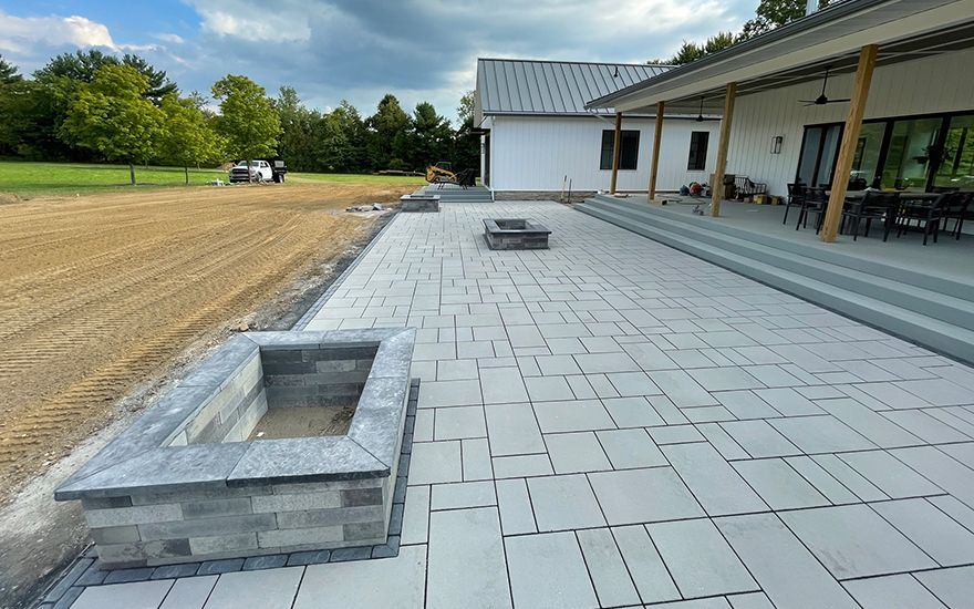 There is a fire pit in the middle of the patio.