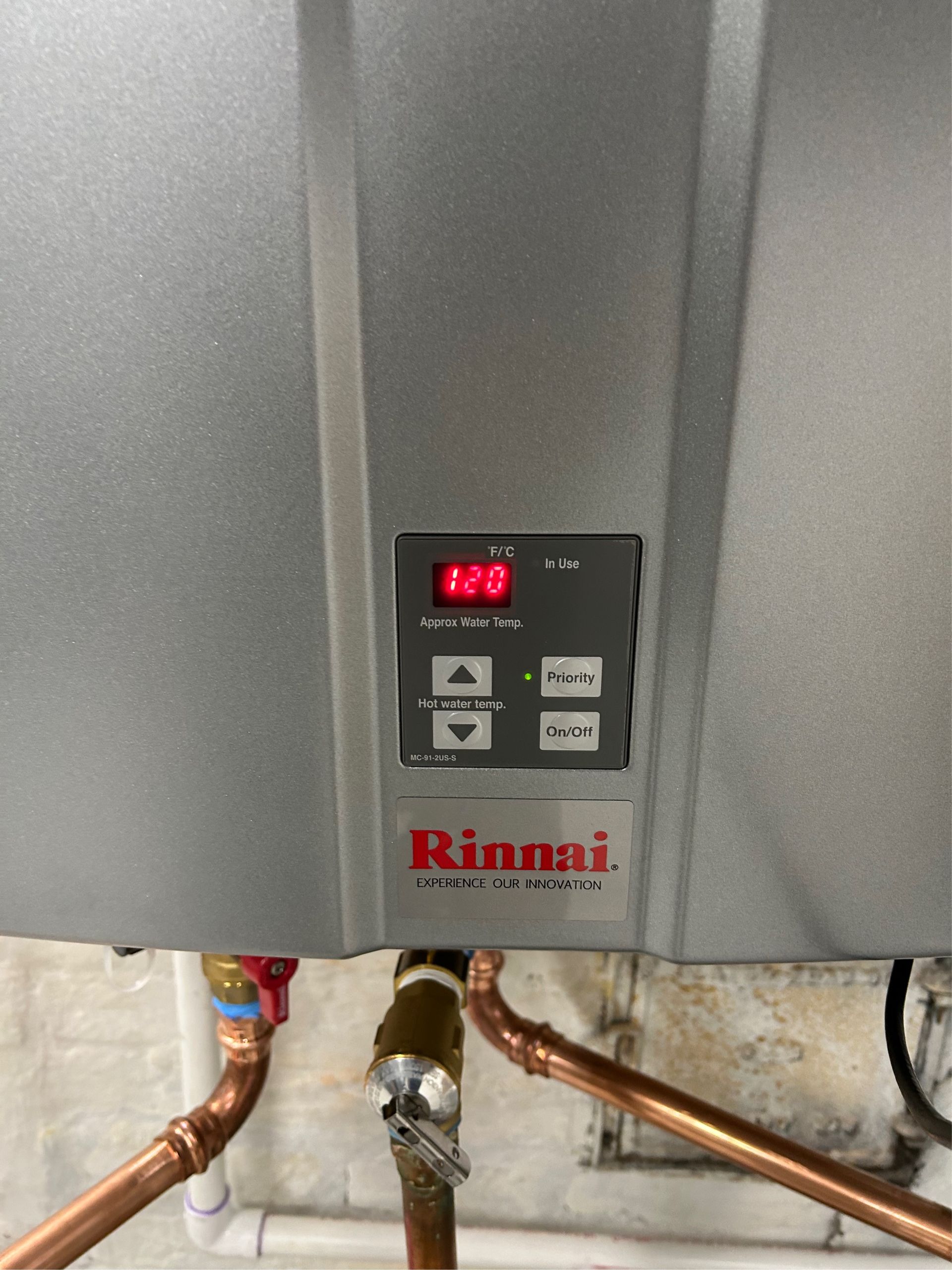 A close-up view of a Rinnai tankless water heater's control panel mounted by Blue Yeti Services.
