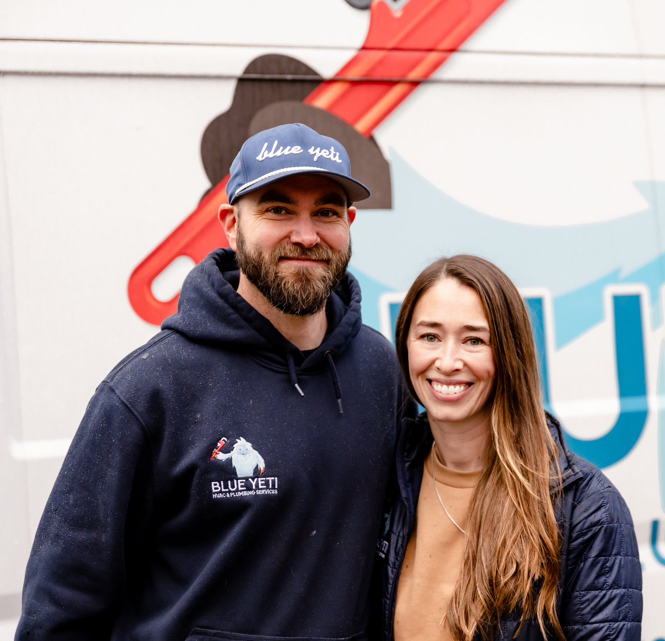 Blue Yeti Service owners in front of service van