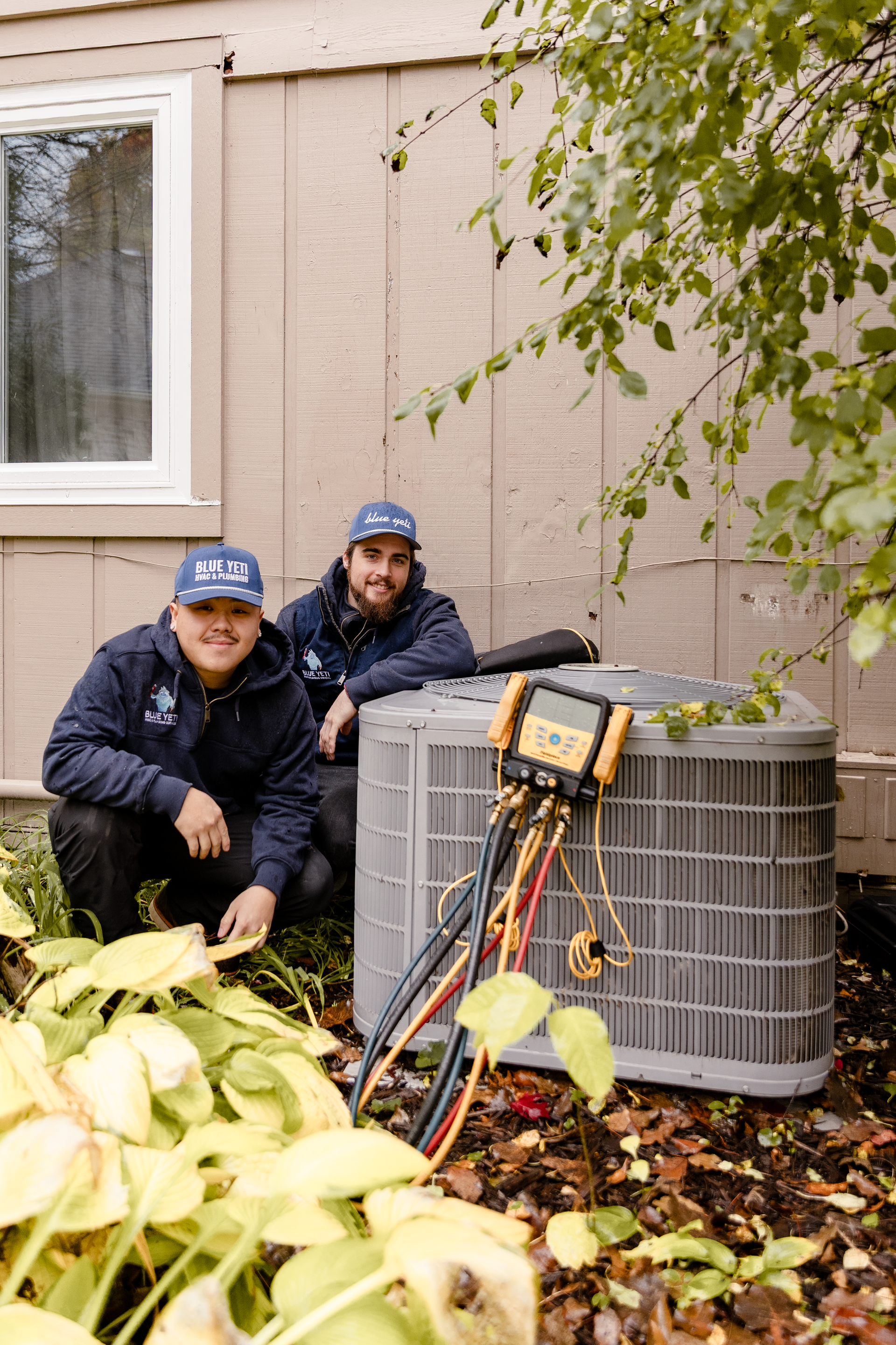 Blue yeti team working on a client's air conditioner