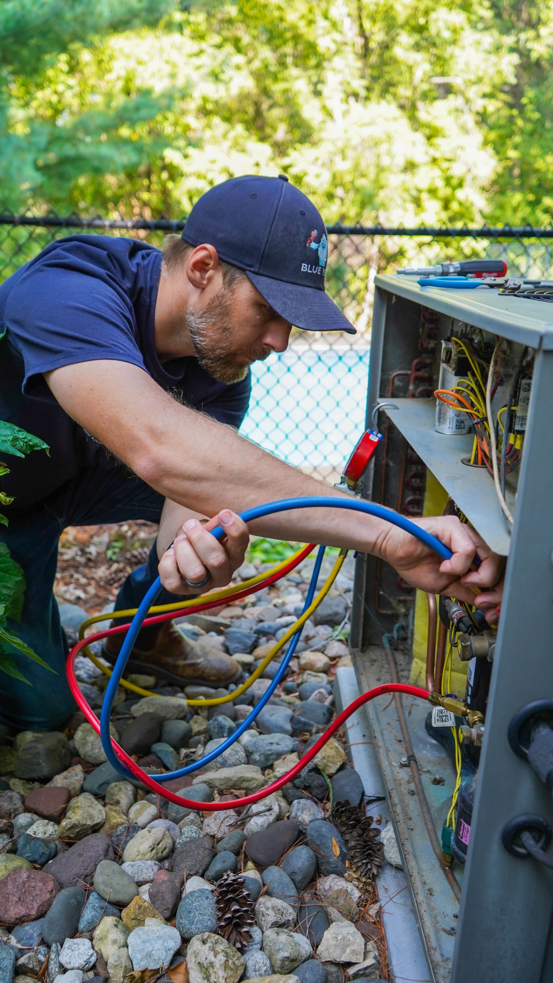 Blue yeti team repairing an air conditioner