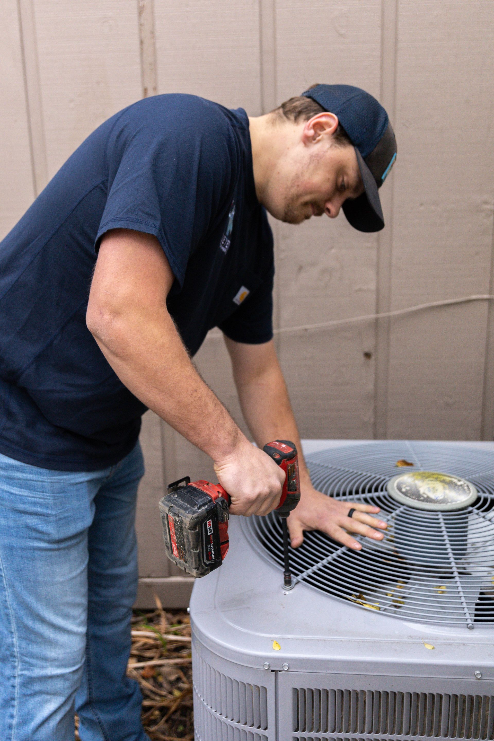 Blue yeti team working on a client's air conditioner