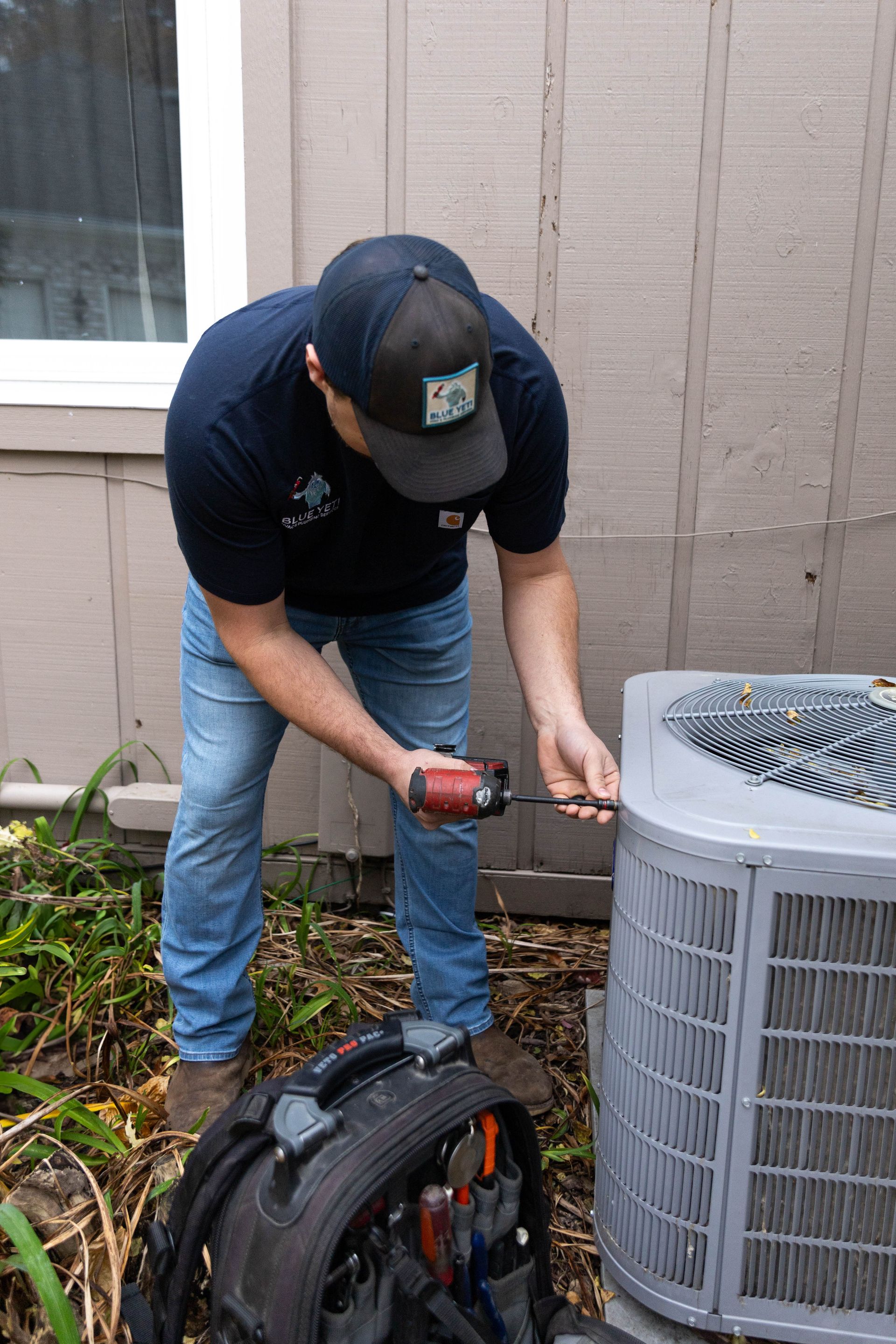 blue yeti services team maintaining an air conditioner