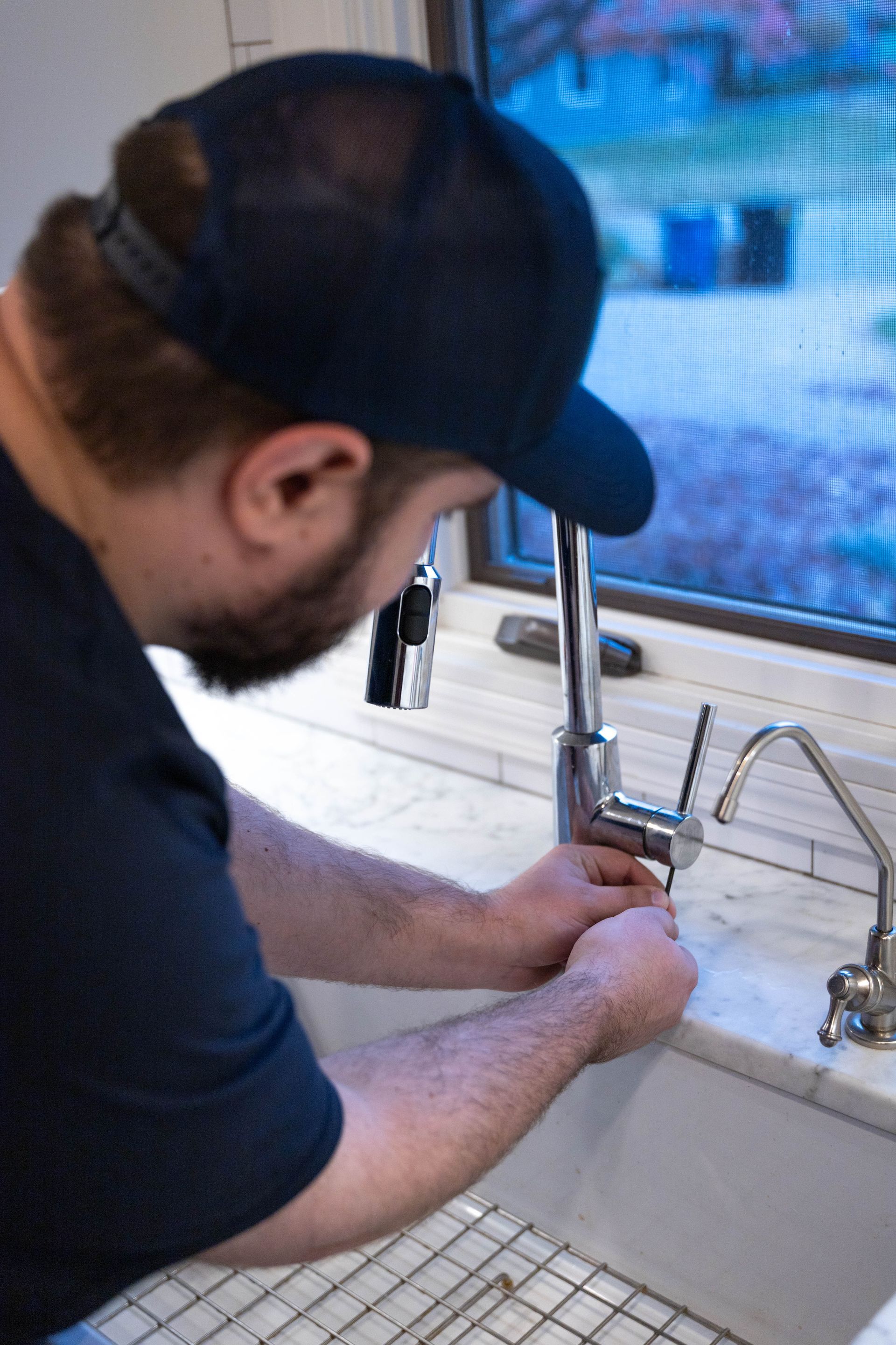 Blue Yeti Service technician inspecting plumbing with a flashlight
