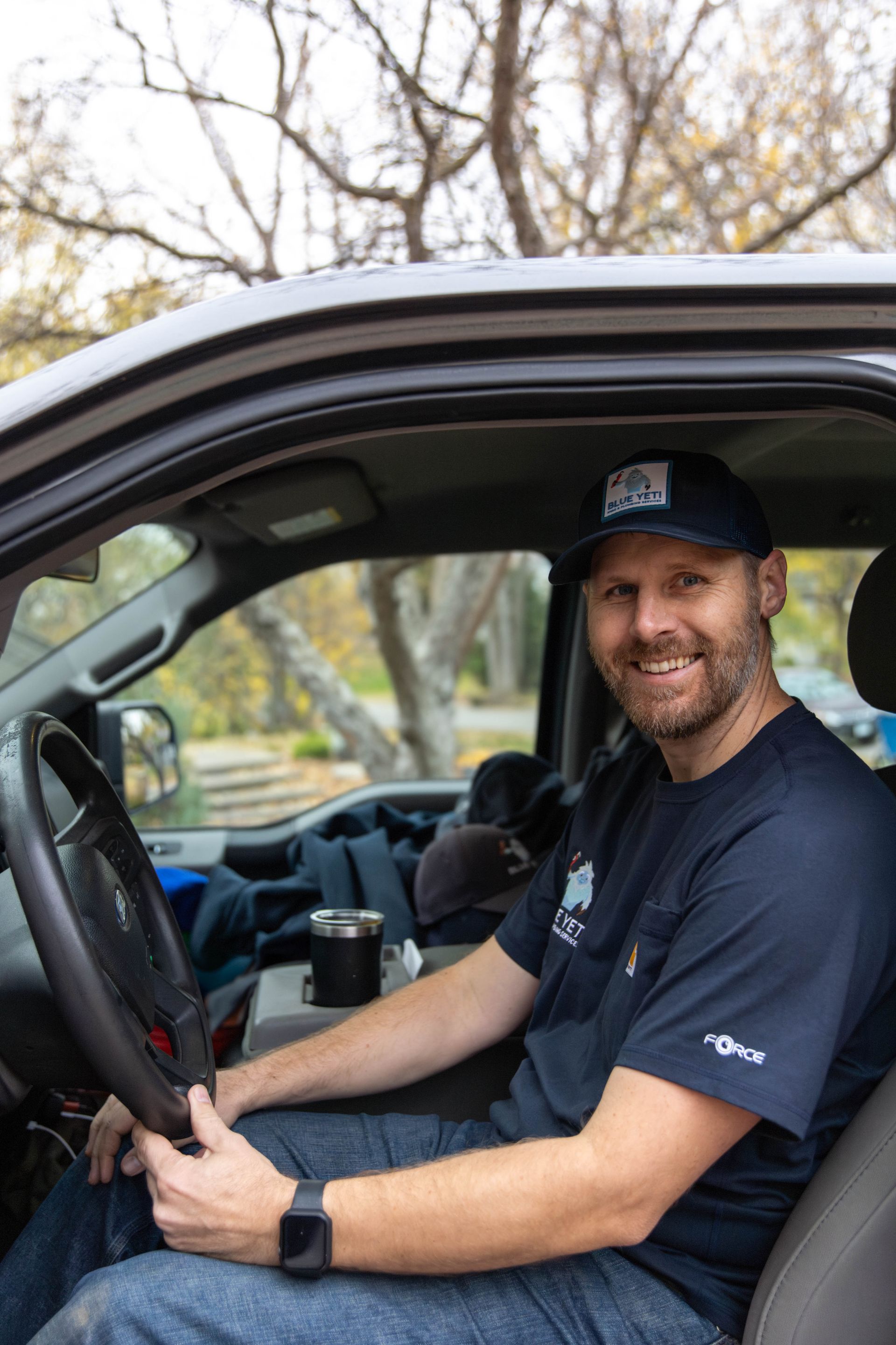 Blue Yeti Service technician in front of their work van