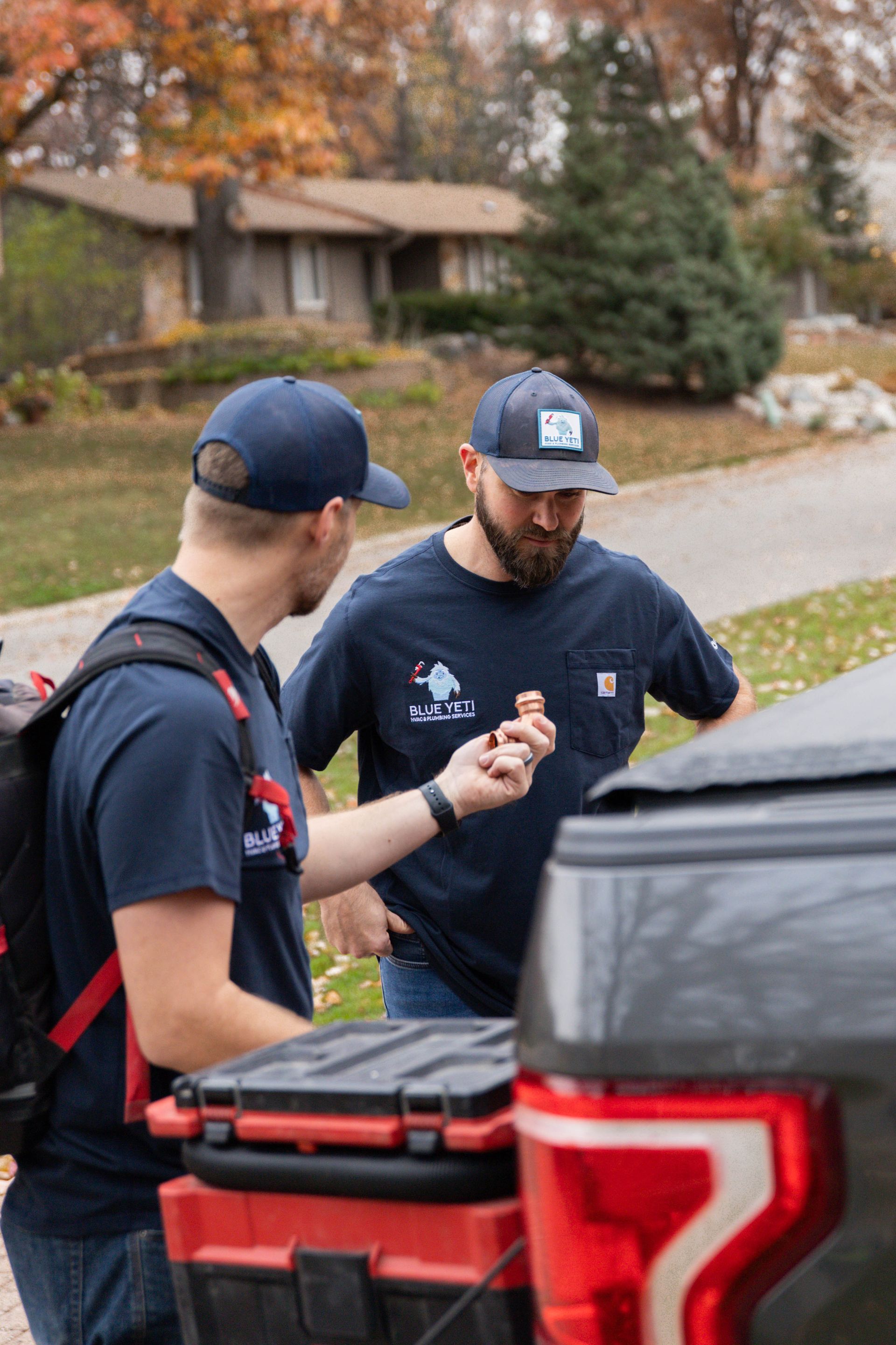Blue Yeti Service technician working on an ac unit outside