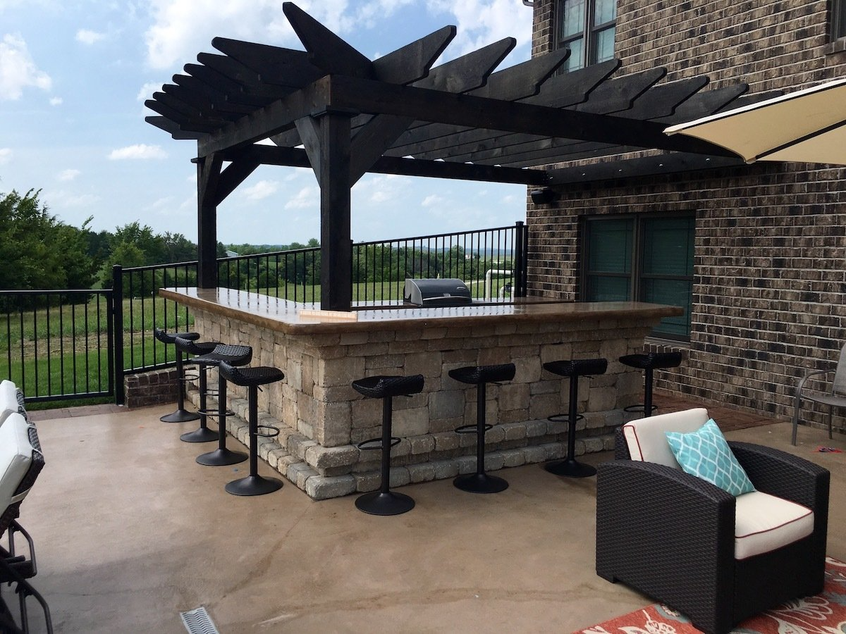 An outdoor kitchen & pergola built by Boulder Creek Lawn & Landscape in Missouri