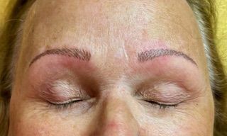 A close up of a woman 's face with her eyes closed.