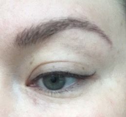 A close up of a woman 's eye with eyeliner