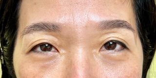 A close up of a woman 's eyes and forehead.