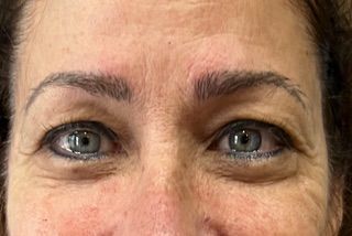 A close up of a woman 's eyes and forehead.