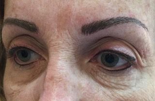 A close up of a woman 's eyes and eyebrows.