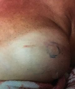 A close up of a person 's chest with a tattoo on it.