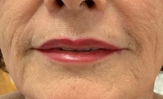 A close up of a woman 's lips with red lipstick.