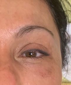 A close up of a woman 's eye and eyebrow.