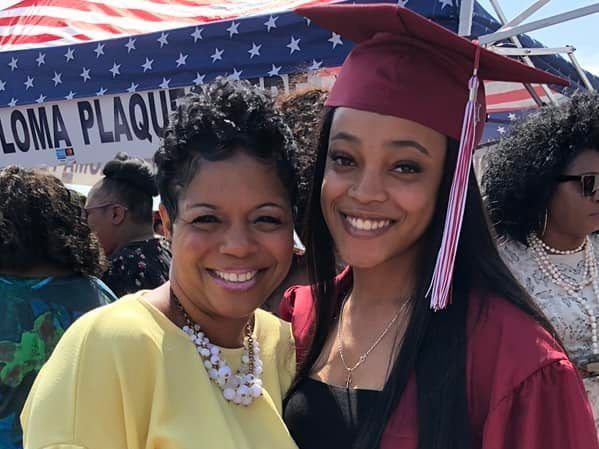 two women are posing for a picture in front of a sign that says loma plaque