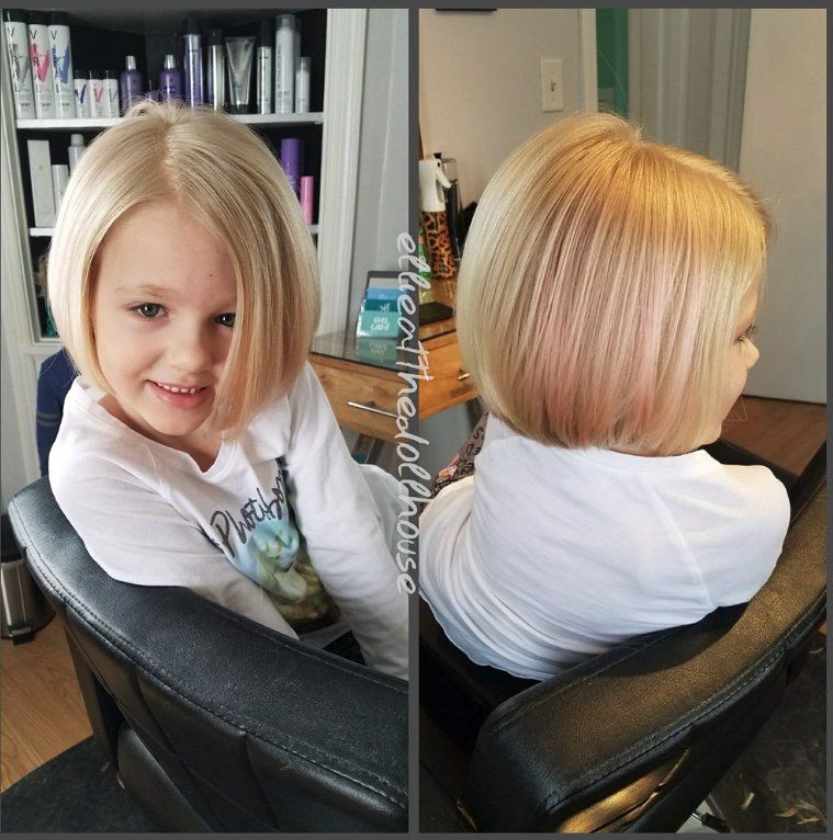 A little girl with blonde hair is sitting in a chair