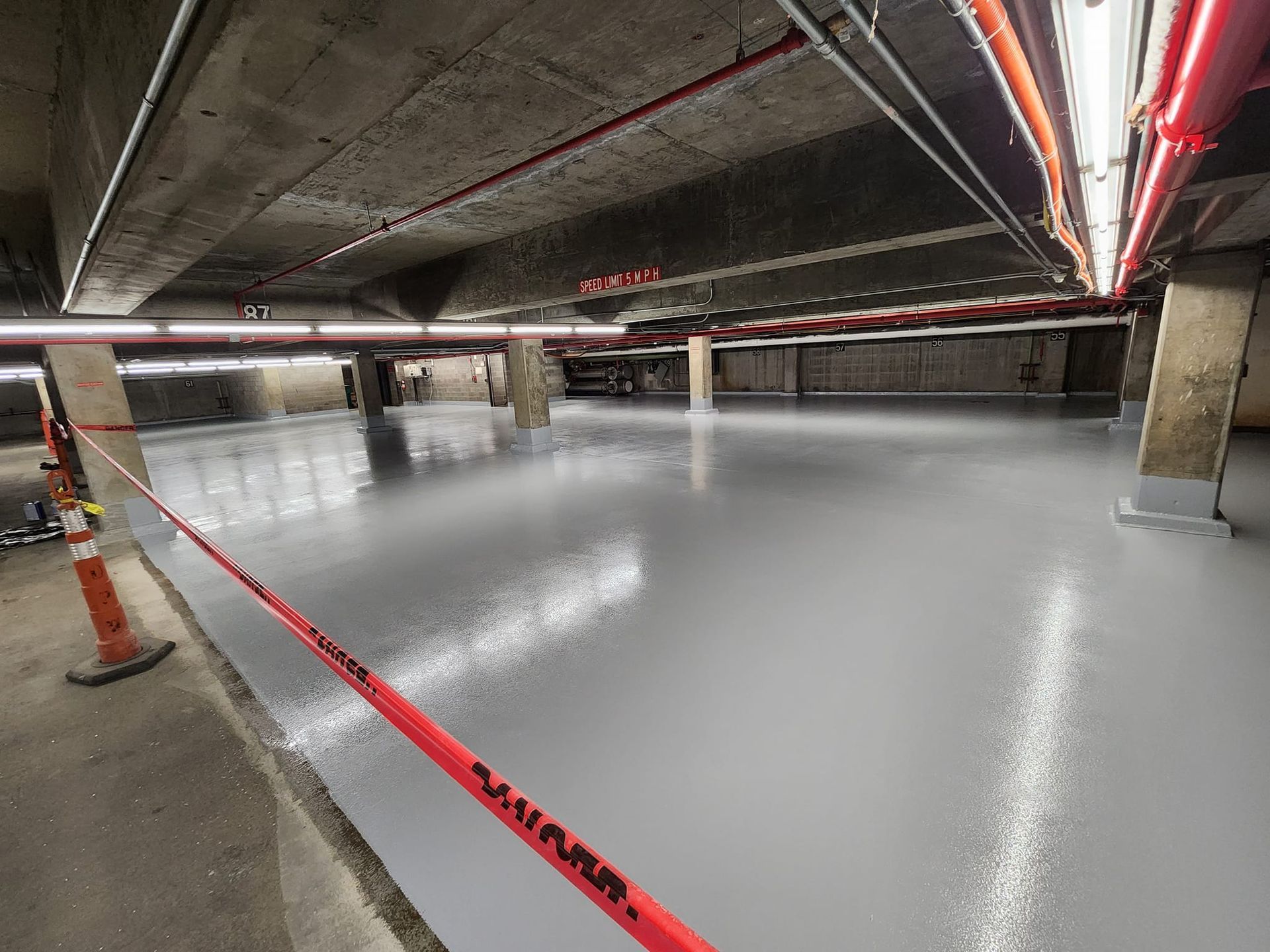 A concrete floor in a parking garage with epoxy membrane.