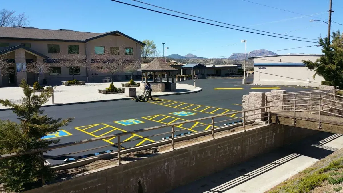 Man Painting the Parking Lot with Yellow Lines — Prescott, AZ — Maurer Sealing & Striping 