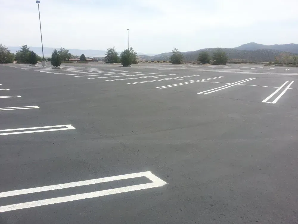 An Empty Parking Lot with Double White Guide Lines — Prescott, AZ — Maurer Sealing & Striping
