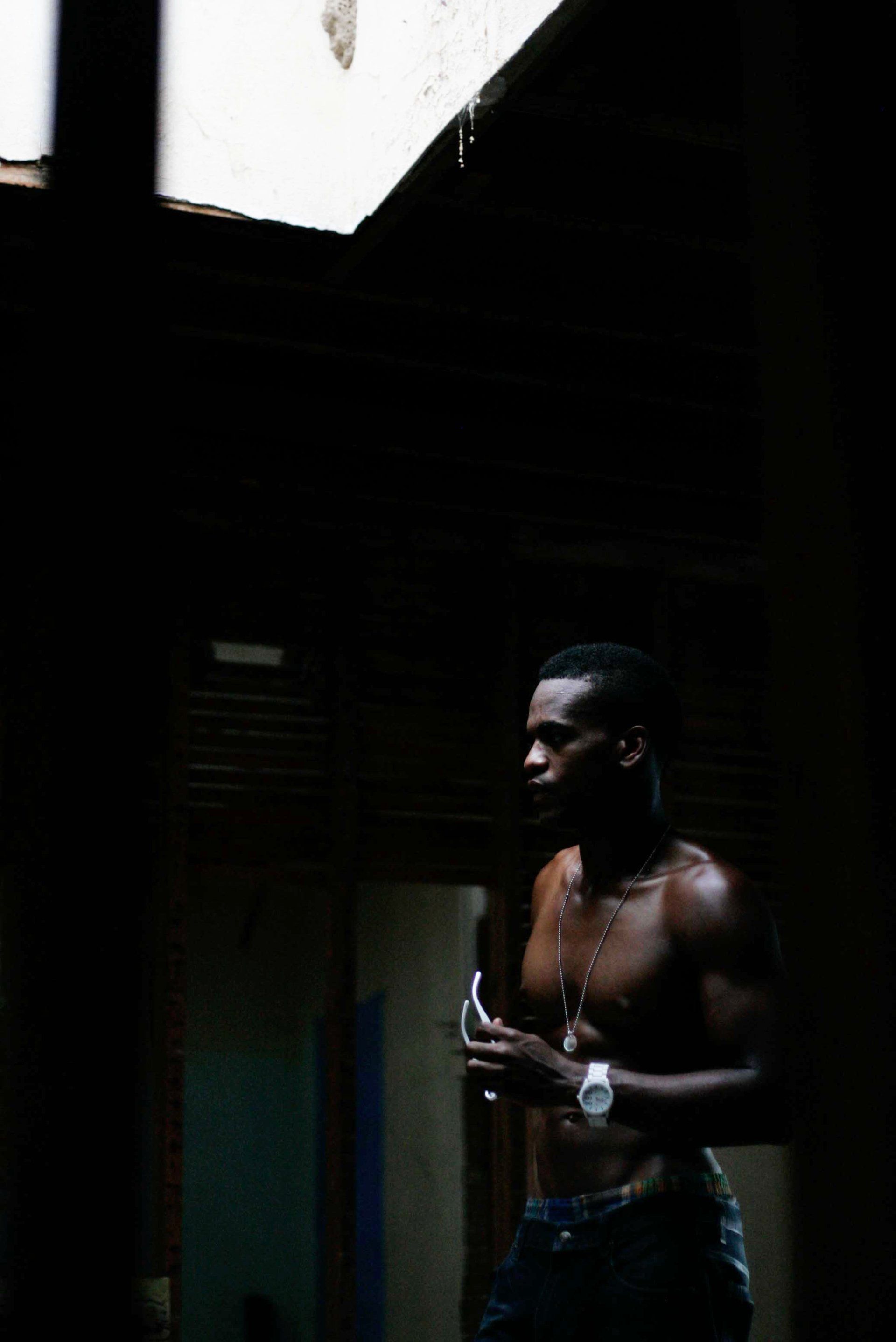 MLN is standing in a dark room