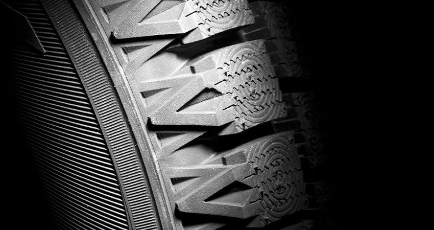 a close up of a tire on a black background .