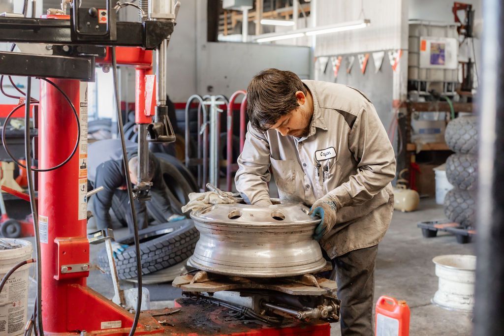 A man is working on a wheel in a garage