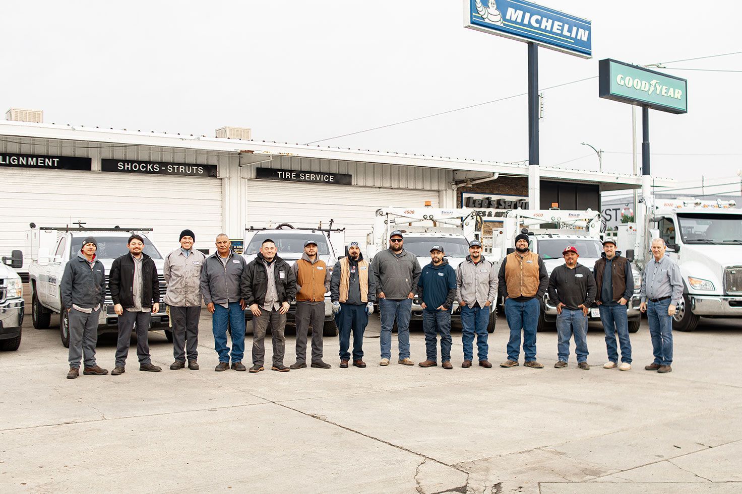 A group of men standing in front of a caterpillar sign