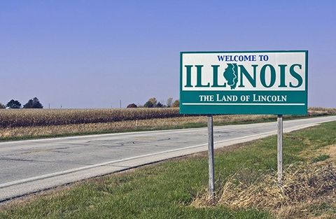 An Illinois state border sign along a highway.