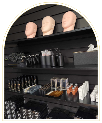 Three Mannequin Heads On Top Shelf With Lash Extension Tools On Lower Shelves — Black Lash Cartel In Mermaid Waters, QLD