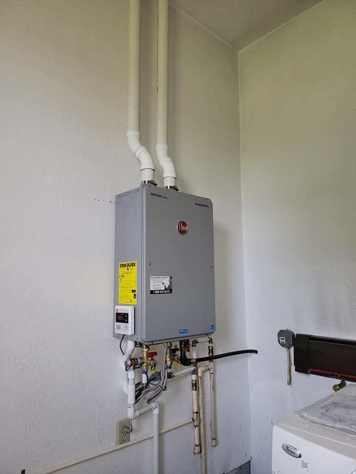 A laundry room with a washer and dryer and a box on the wall.