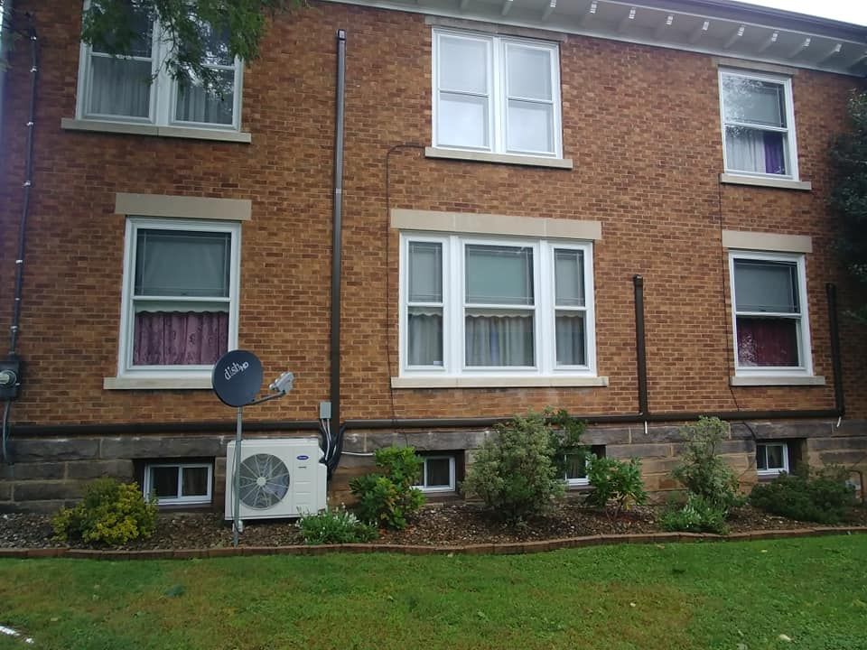 A brick building with a satellite dish on the side