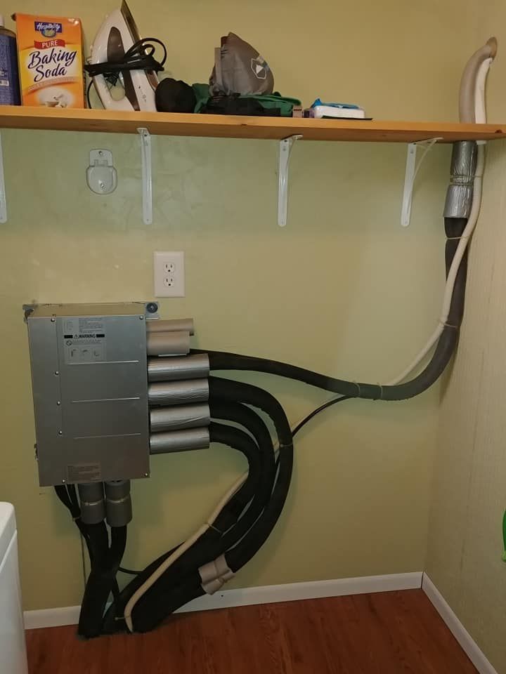 A box of kraft paper towels sits on a shelf in a laundry room