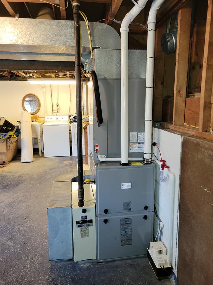A basement with a furnace and a washer and dryer.