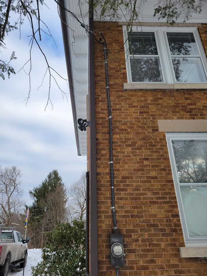 A brick house with a white truck parked in front of it.
