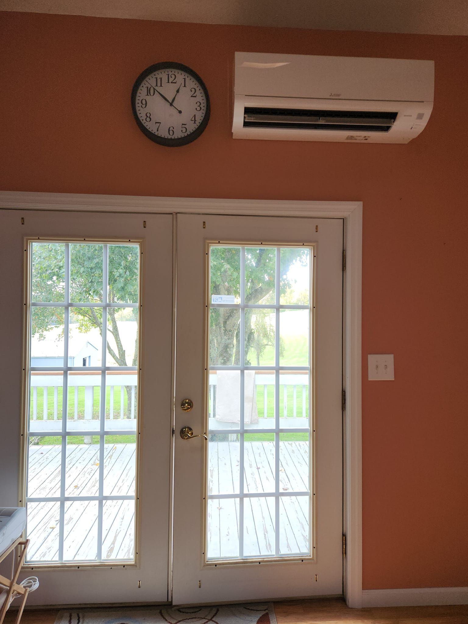 A room with a clock on the wall above the door