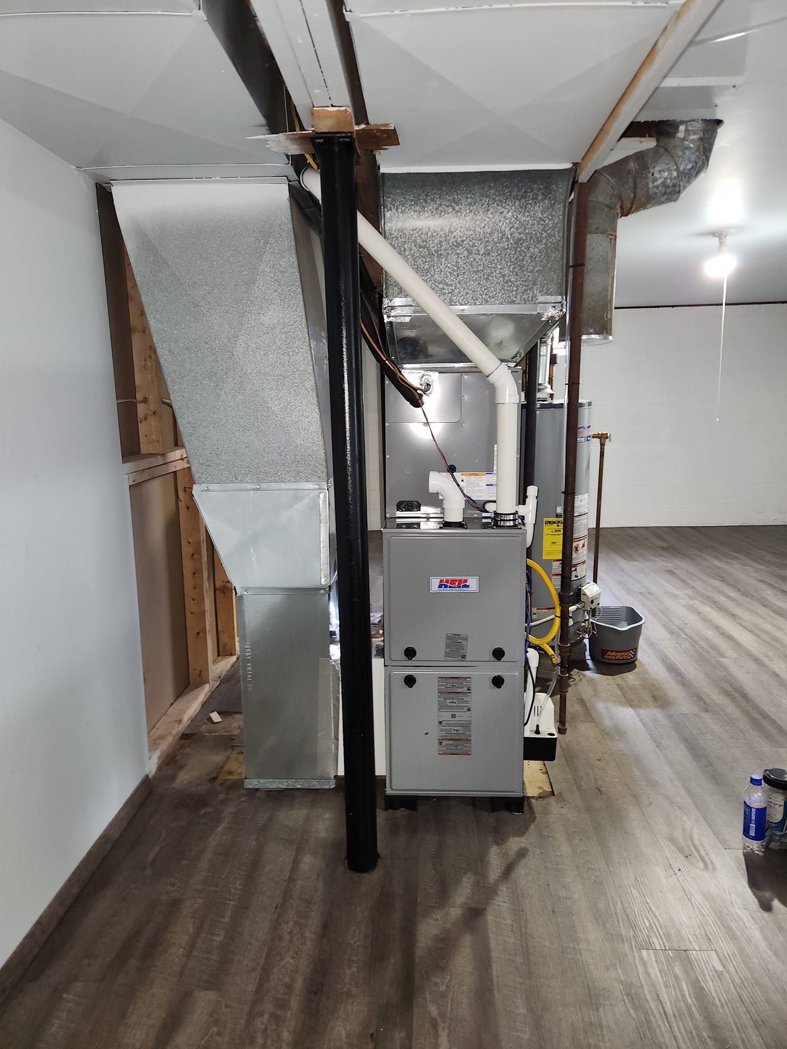 A basement with a furnace and air conditioner in it.