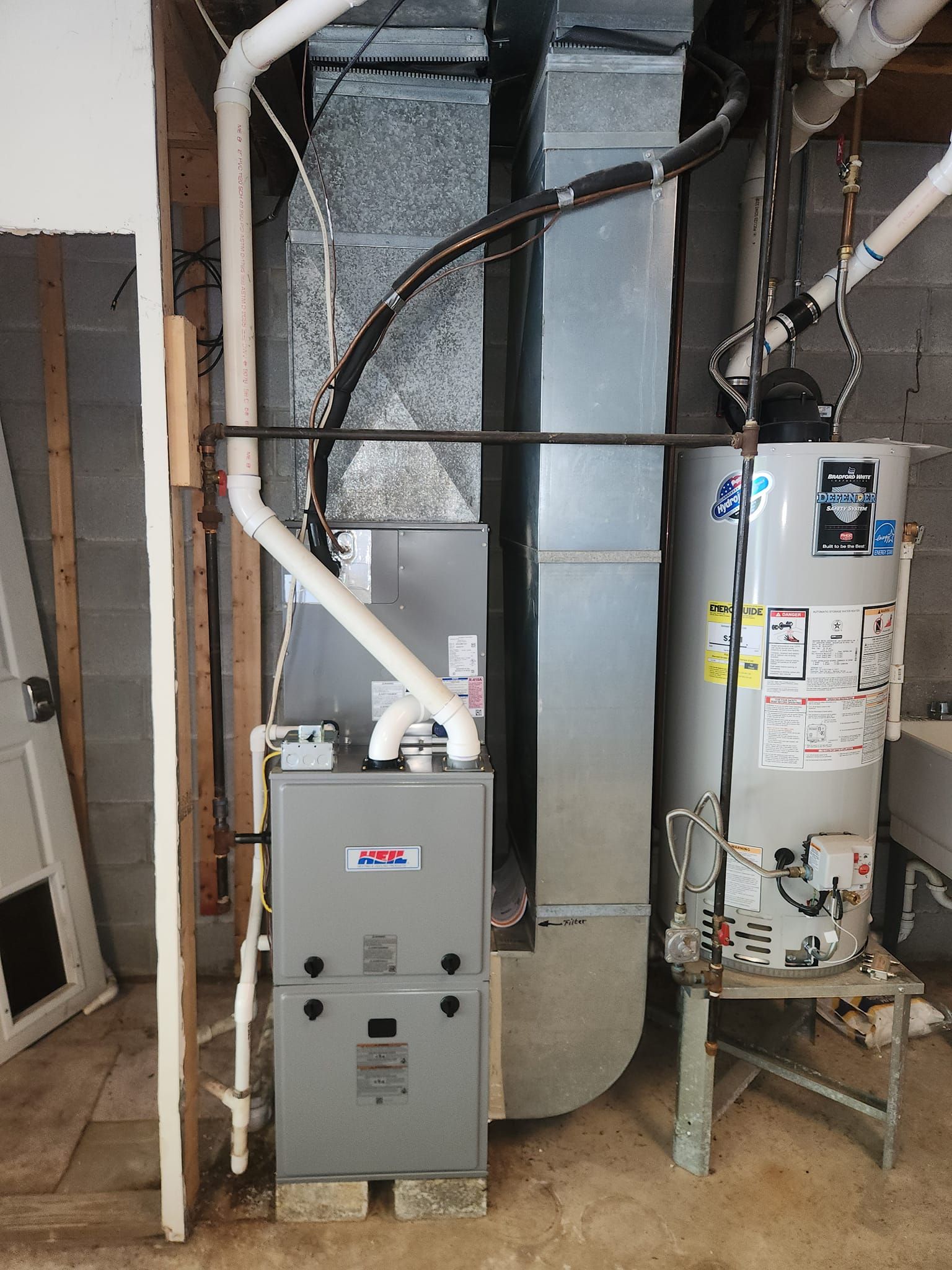 There is a water heater and a furnace in the basement.