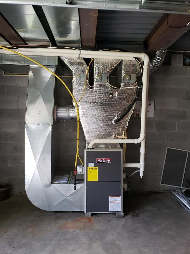 A heating and cooling system is installed in a basement.
