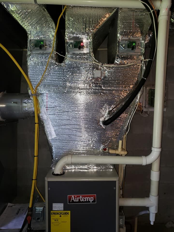 An air temp air conditioner is being installed in a basement.