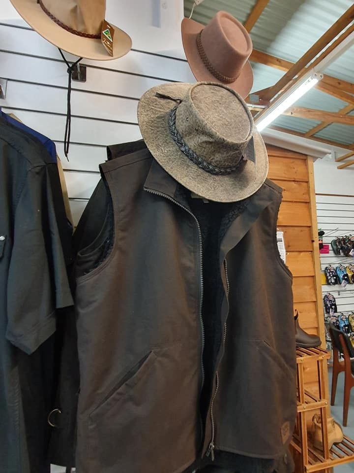 A Cowboy Hat Is Hanging On A Vest In A Store — Maleny Hardware & Rural Supplies In Maleny, QLD