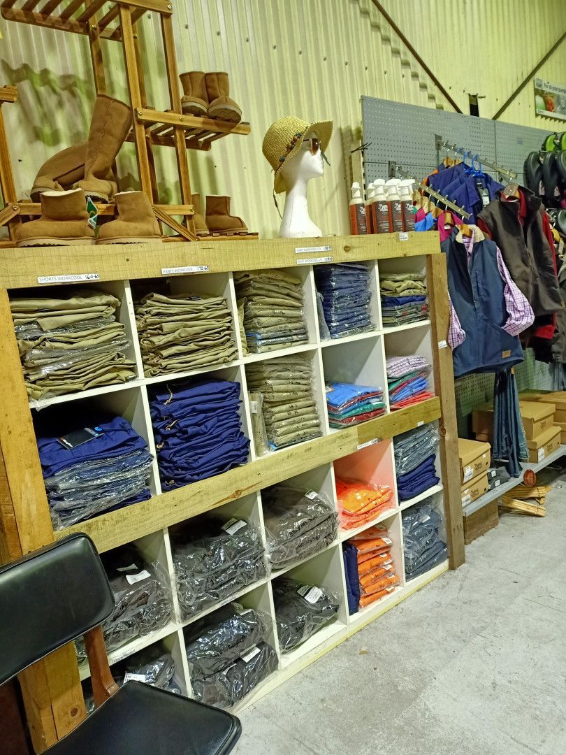A Bunch Of Clothes Are Folded In A Store — Maleny Hardware & Rural Supplies In Maleny, QLD