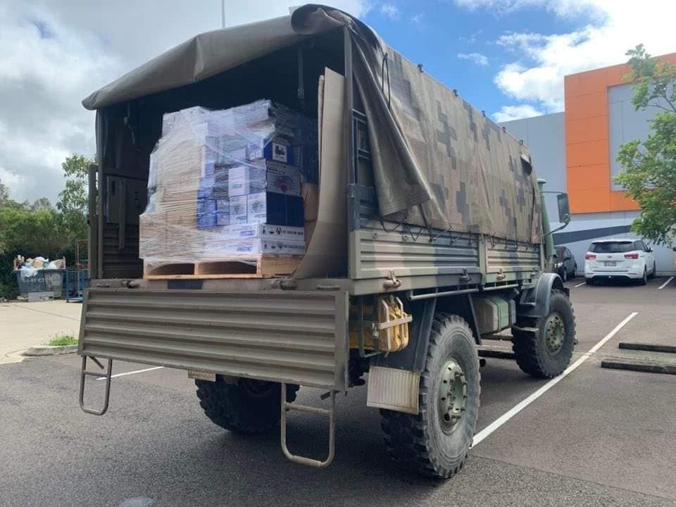 A Military Truck With Boxes In The Back Is Parked In A Parking Lot — Maleny Hardware & Rural Supplies In Maleny, QLD