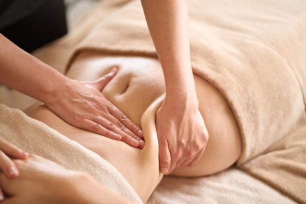 A Woman Is Getting a Massage on Her Stomach at a Spa — Ocean Isle Beach, NC — OIB Massage
