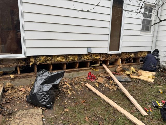 A man is working on the foundation of a house.