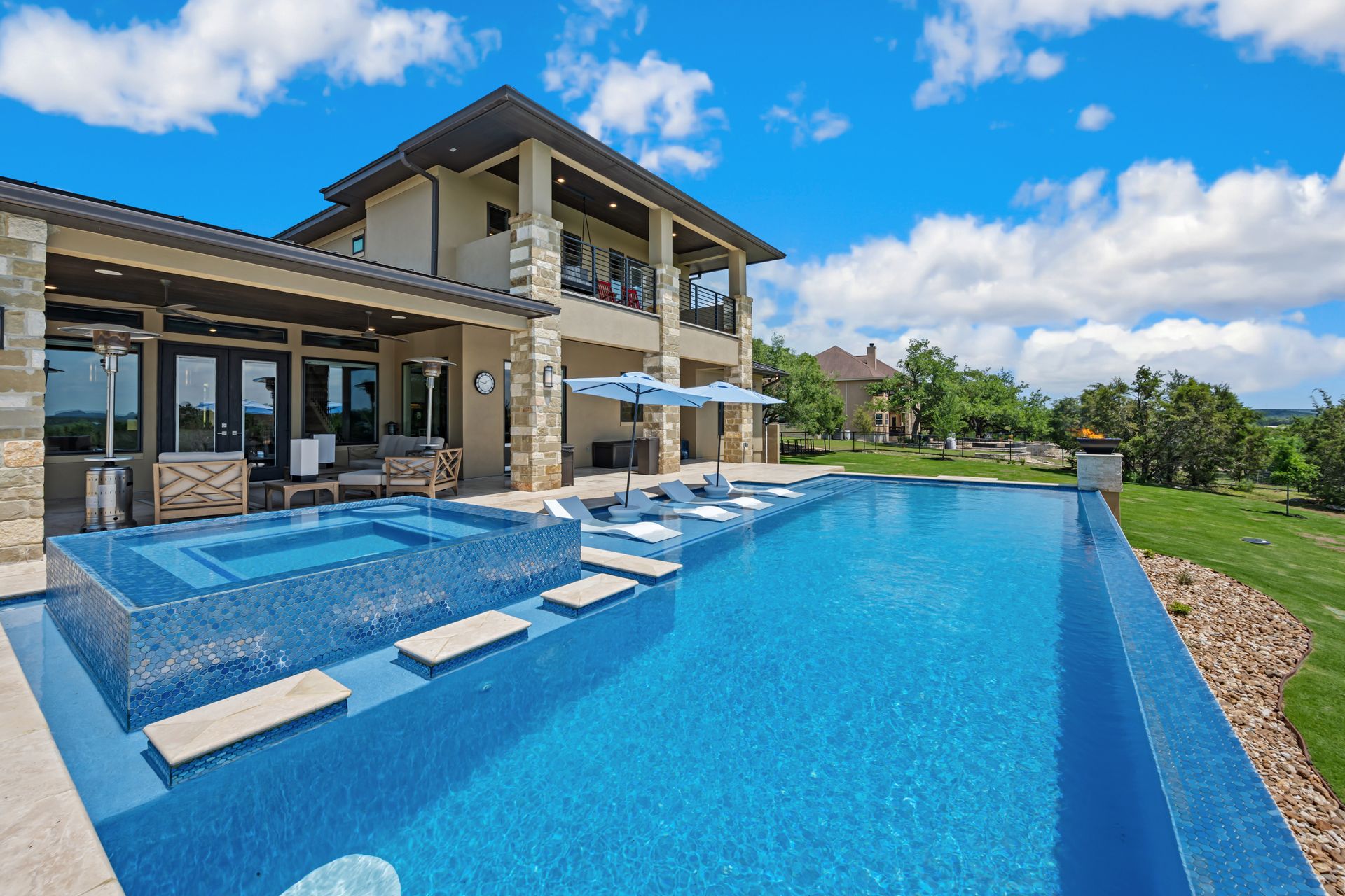 A large house with a large swimming pool in front of it