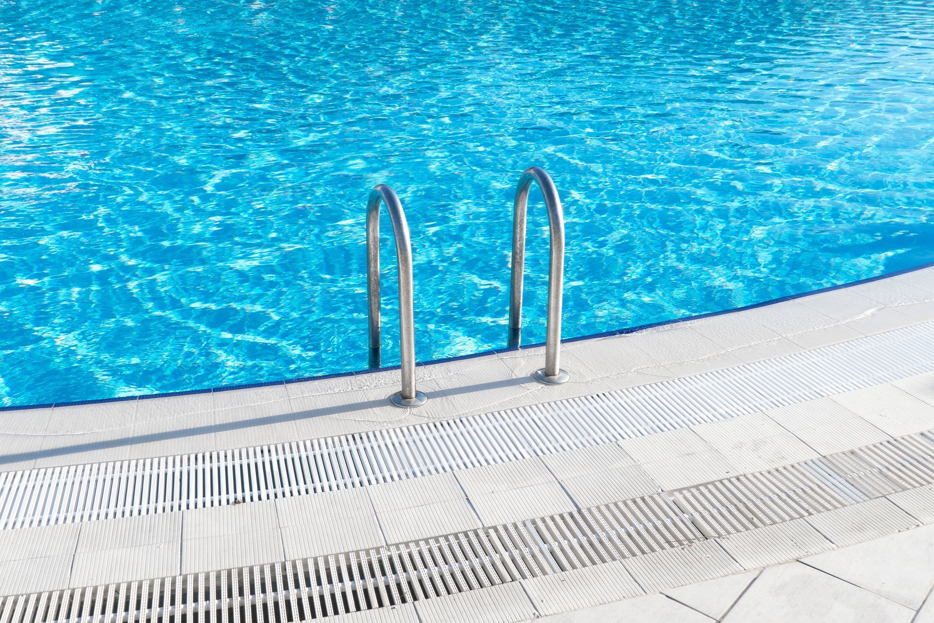 A swimming pool with stairs leading to the water.