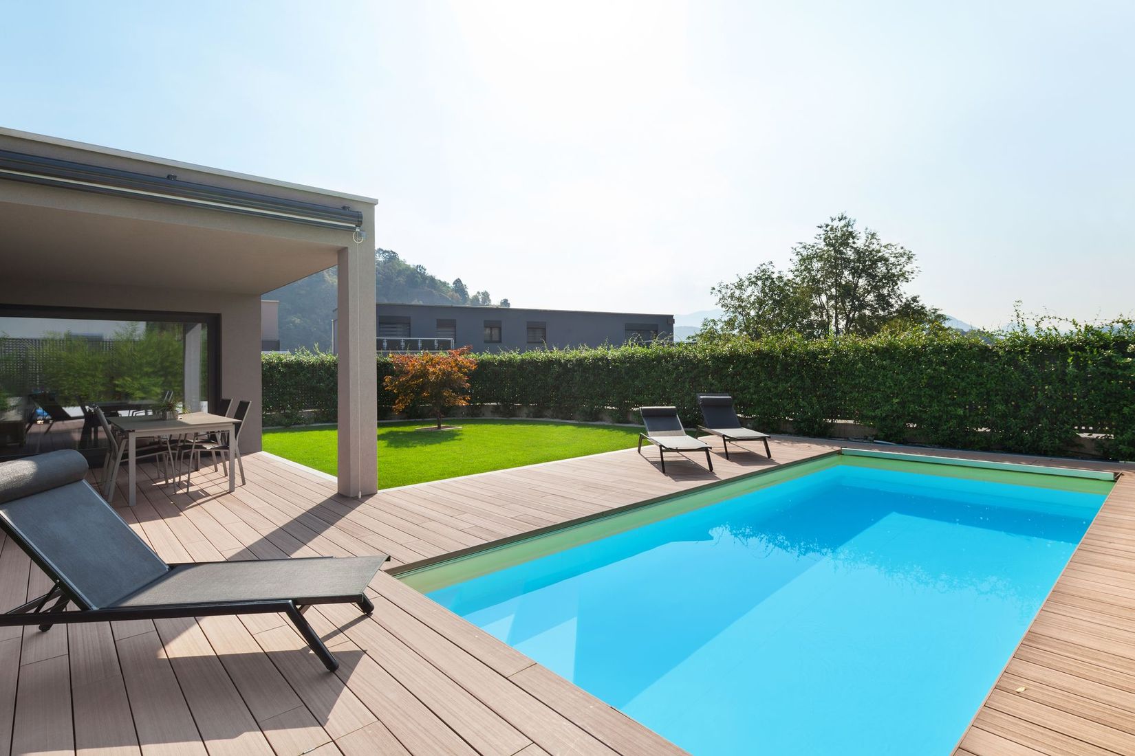 A large swimming pool in the backyard of a house