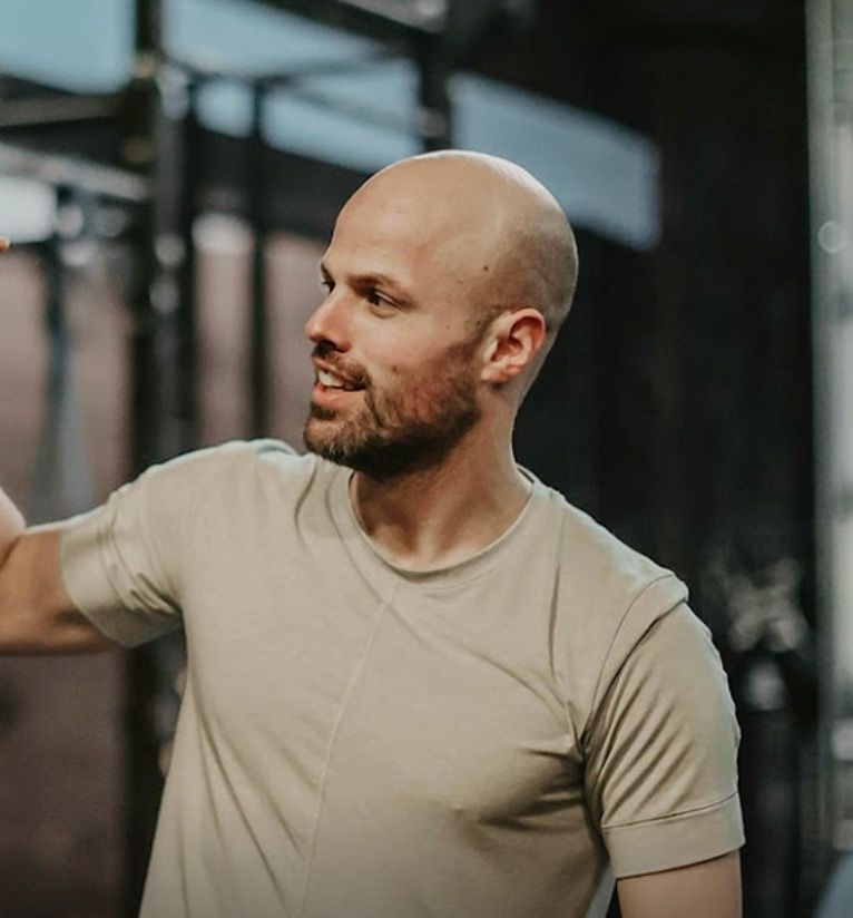 A man wearing headphones and a watch is running.