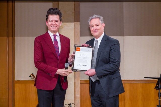 Erik Olson-Kikuchi - ACCJ Chubu Volunteer of the Year - receiving her award on stage